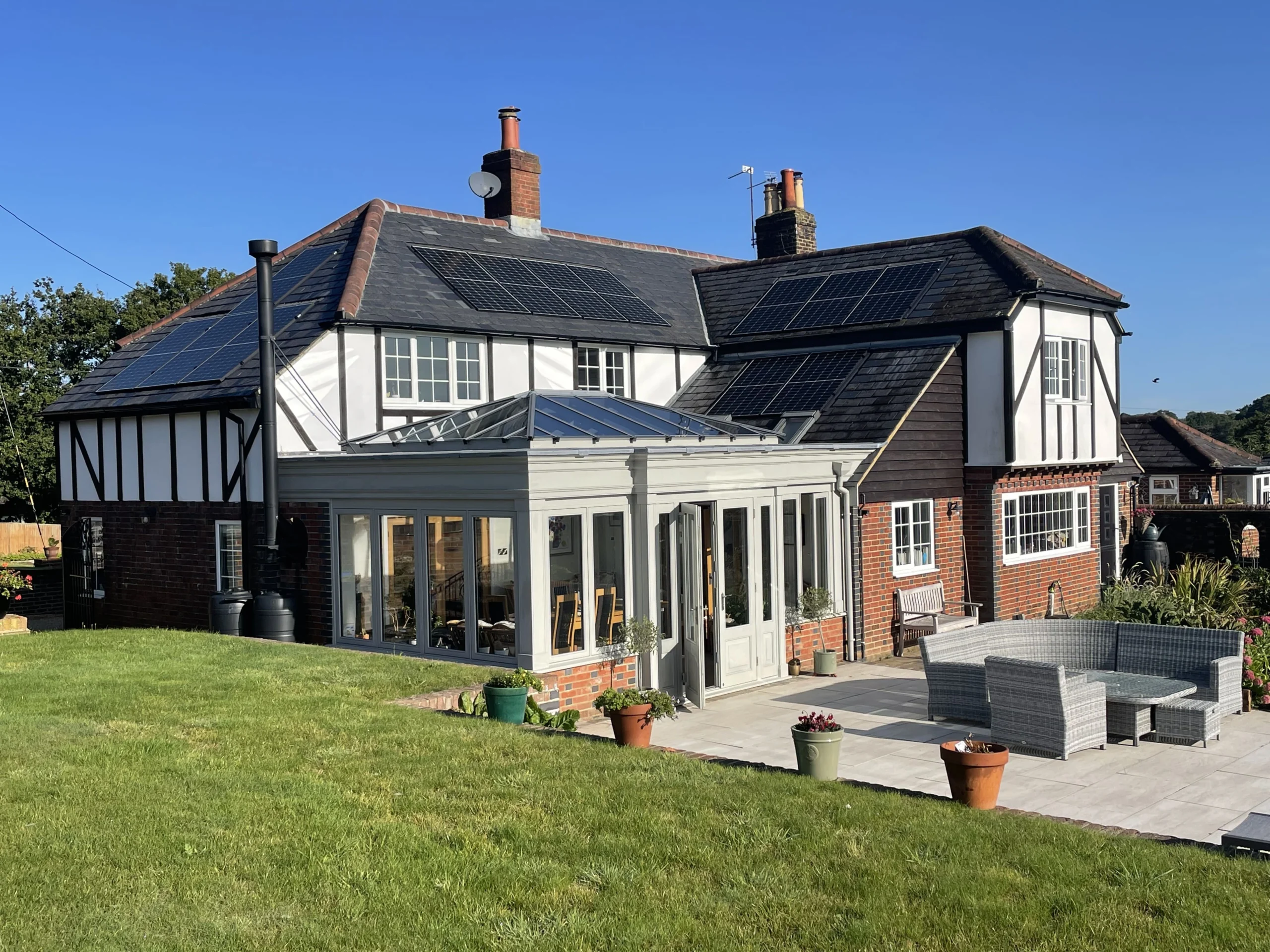 Large residential home with solar panels on multiple roofs