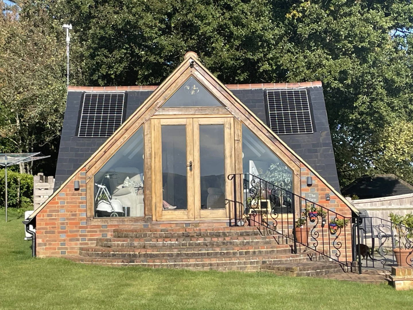 Large residential home with solar panels on multiple roofs