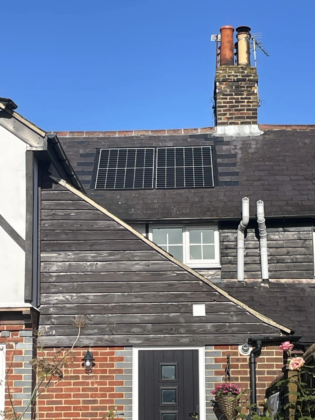 Large residential home with solar panels on multiple roofs