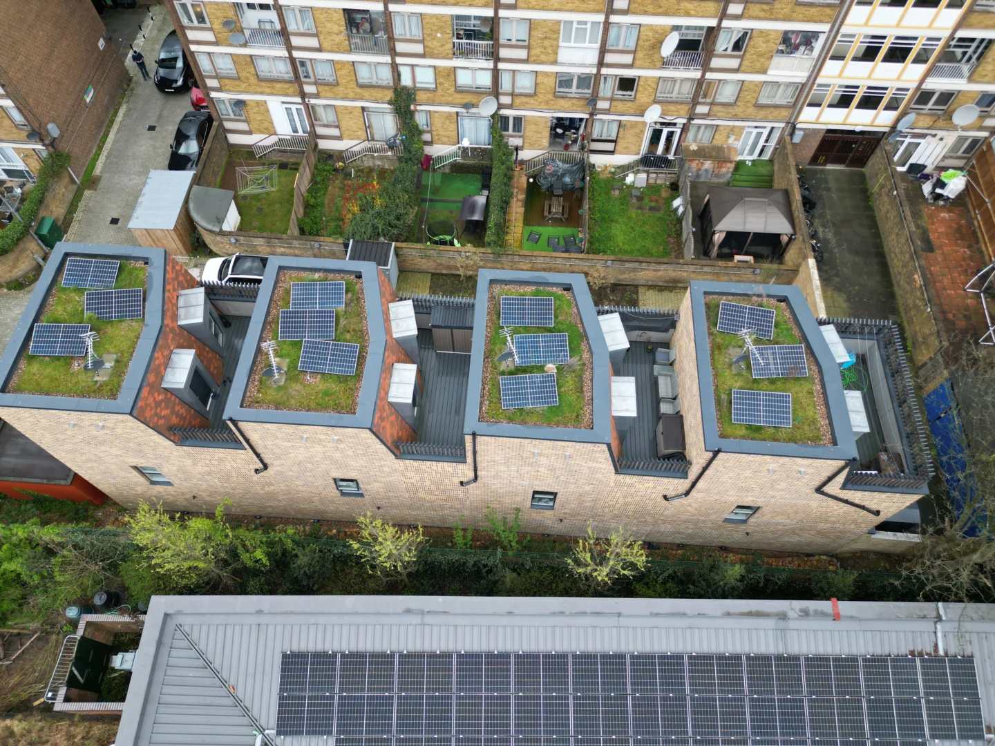 Aerial view of solar panels on roofs of modern residential development