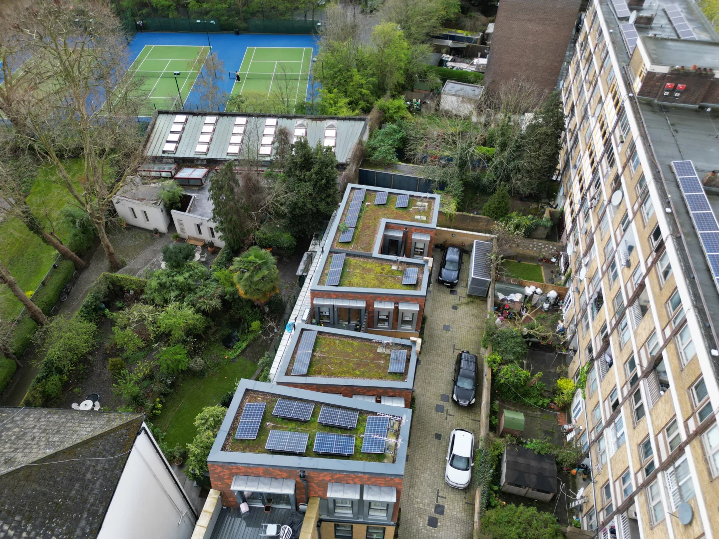 Aerial view of solar panels on roofs of modern residential development