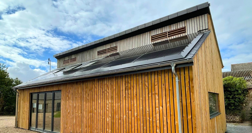 Wooden house with solar panel installation